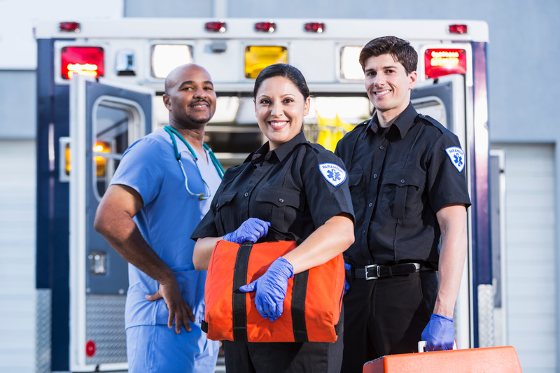 Paramedics and doctor outside ambulance image